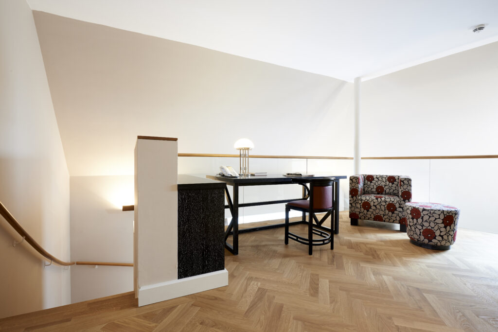Workspace with a lamp and a landline phone in the attic apartment